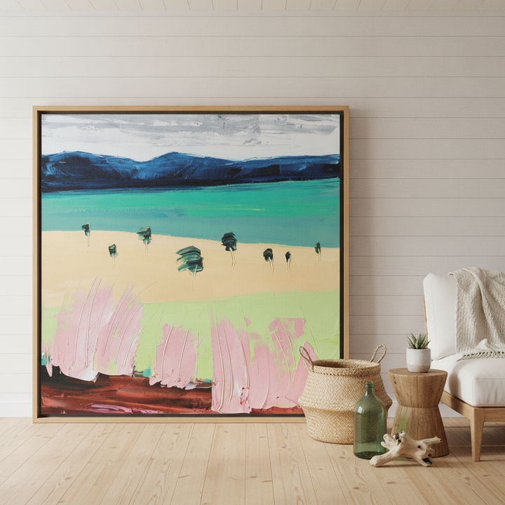 Oversized statement canvas wall art with a natural timber surround leaning against the wall in a coastal bedroom