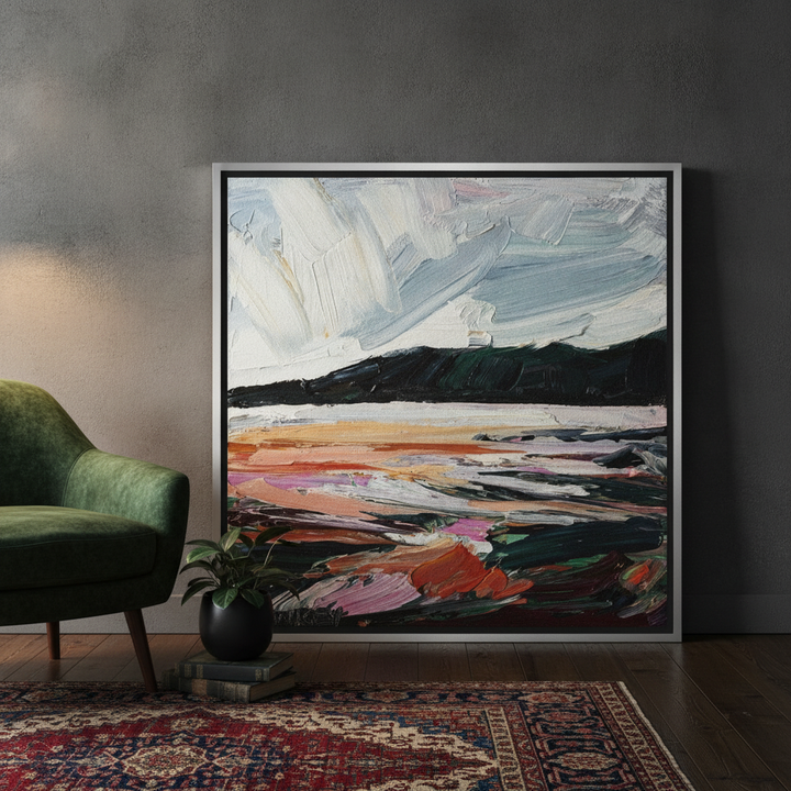 Oversized statement canvas wall art with a silver leaf surround leaning against the wall in a moody living room