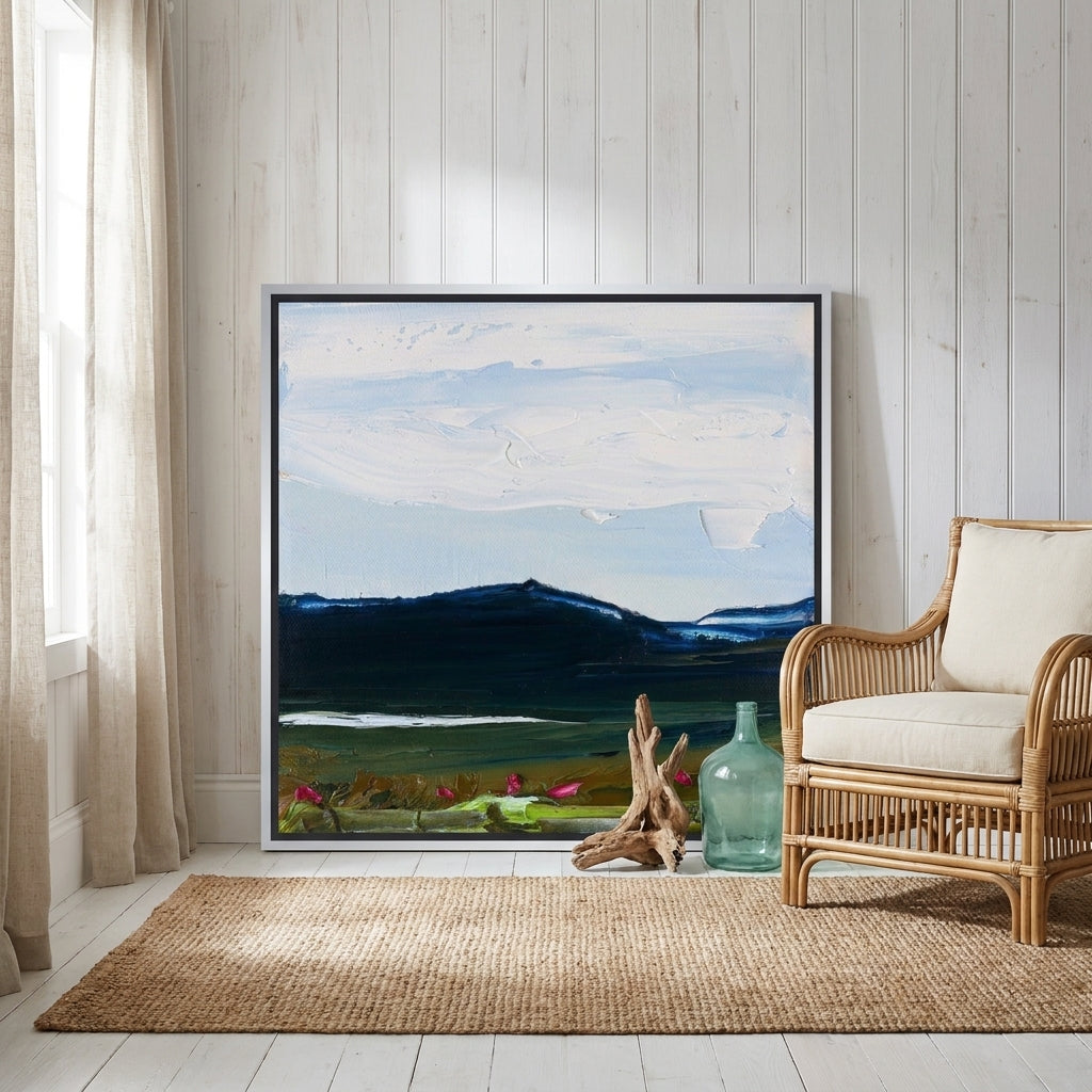 Canvas wall art with a silver leaf surround leaning against the wall in a coastal bedroom