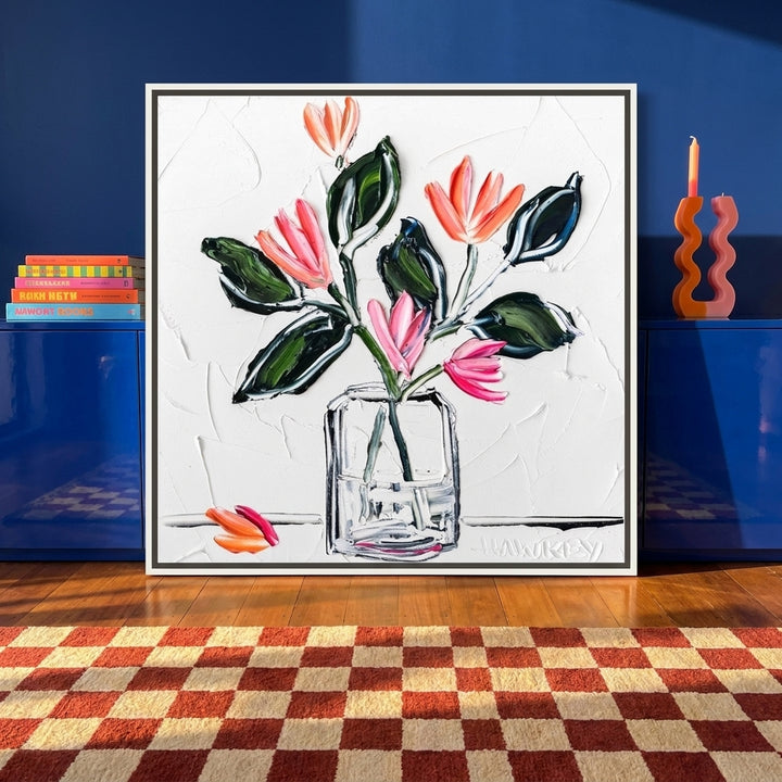 Canvas wall art with a white surround standing on a sideboard in a colourful eclectic bedroom