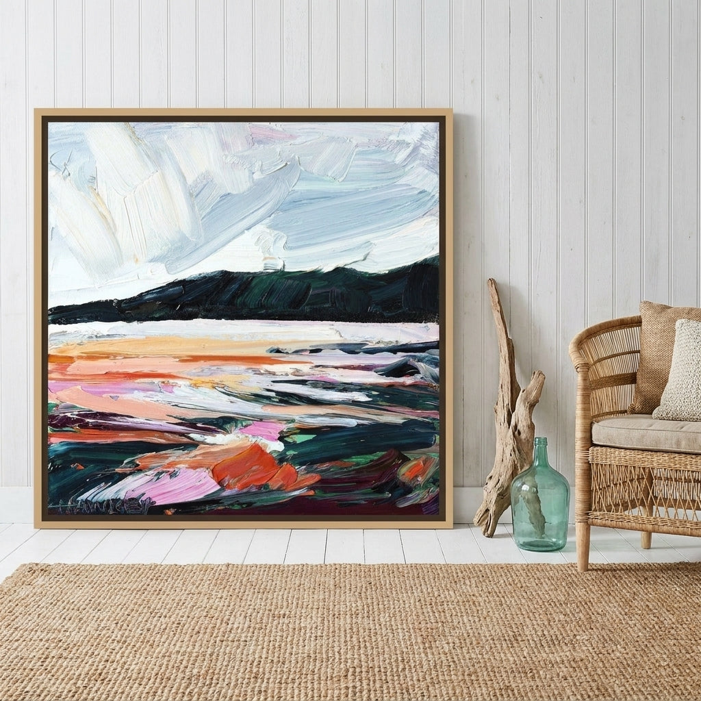 Canvas wall art with a natural timber surround leaning against the wall in a coastal home office