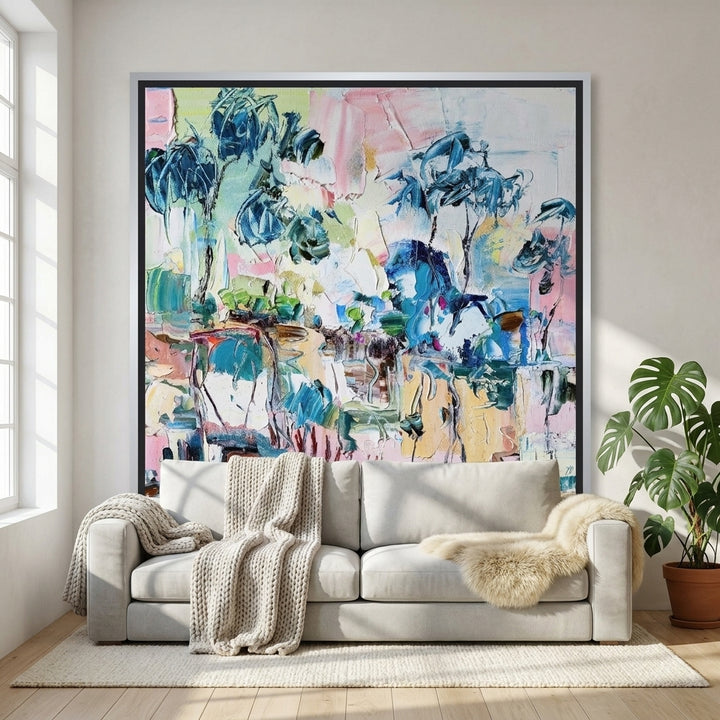 Canvas wall art with a silver leaf surround styled on the wall in a bright Scandinavian living room