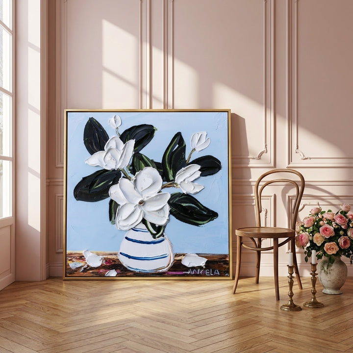 Canvas wall art with a gold leaf surround leaning against the wall in a Parisian bathroom
