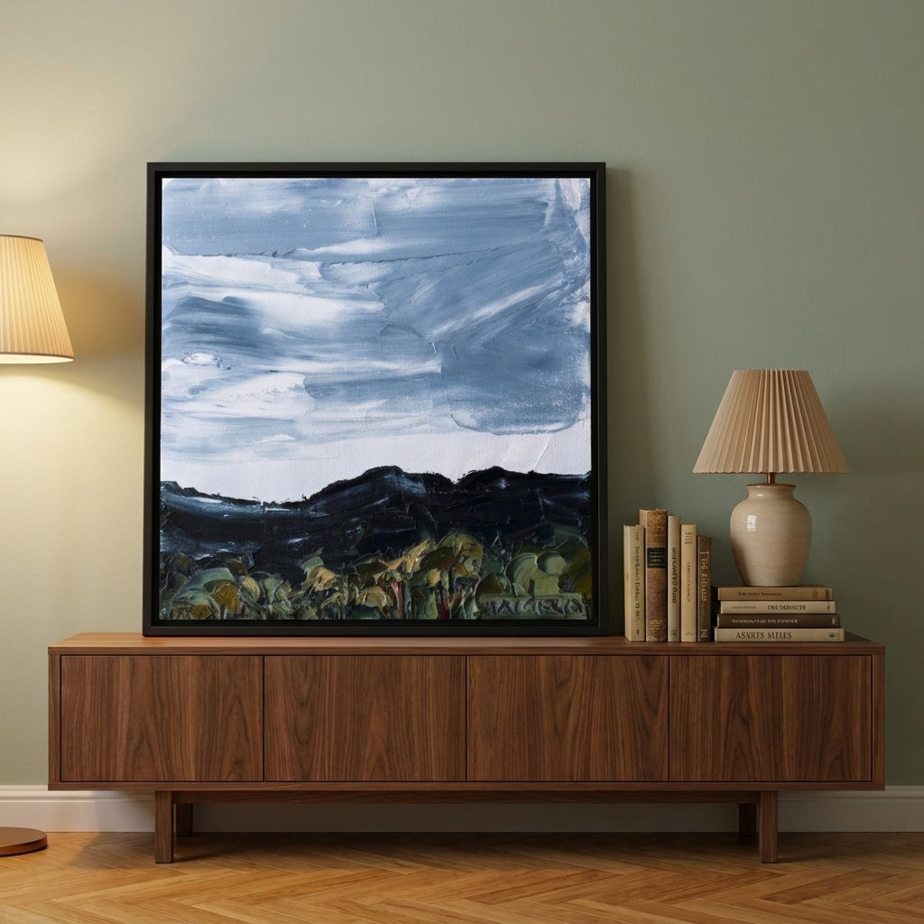 Canvas wall art with a black surround standing on a sideboard in a mid-century bedroom