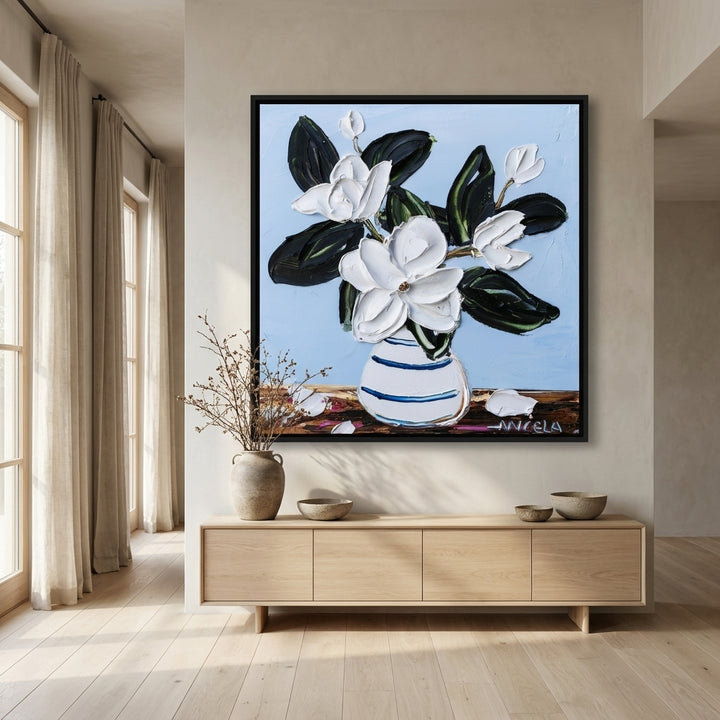 Oversized statement canvas wall art with a black surround styled on the wall in a warm Japandi living room