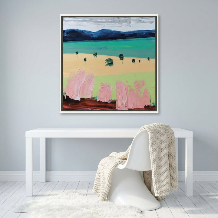 Canvas wall art with a white surround styled on the wall in a bright Scandinavian home office