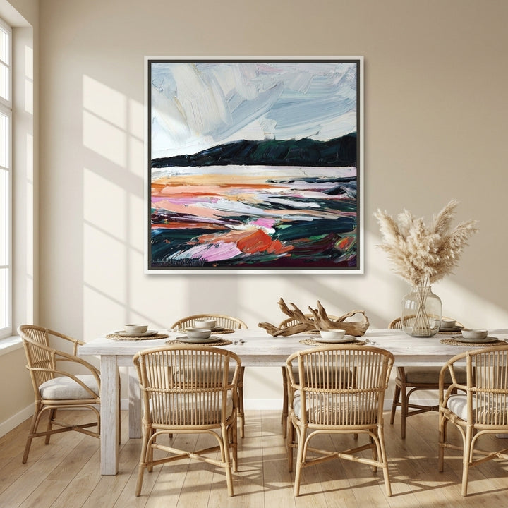 Canvas wall art with a white surround styled on the wall in a coastal dining room