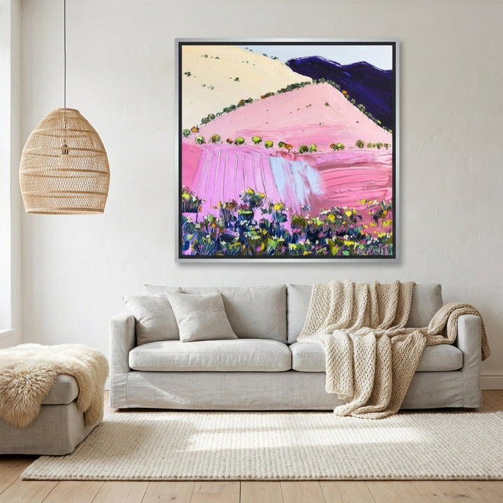 Canvas wall art with a silver leaf surround styled on the wall in a bright Scandinavian living room
