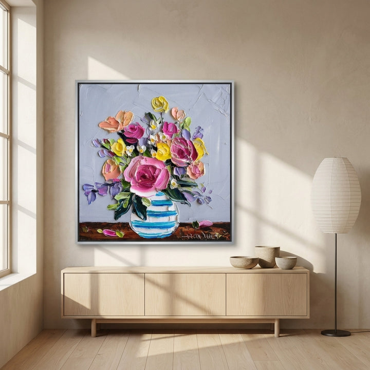 Canvas wall art with a silver leaf surround styled on the wall in a warm Japandi living room