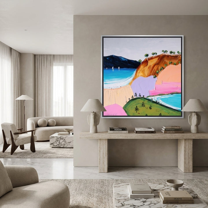 Oversized statement canvas wall art with a silver leaf surround styled on the wall in a luxe living room