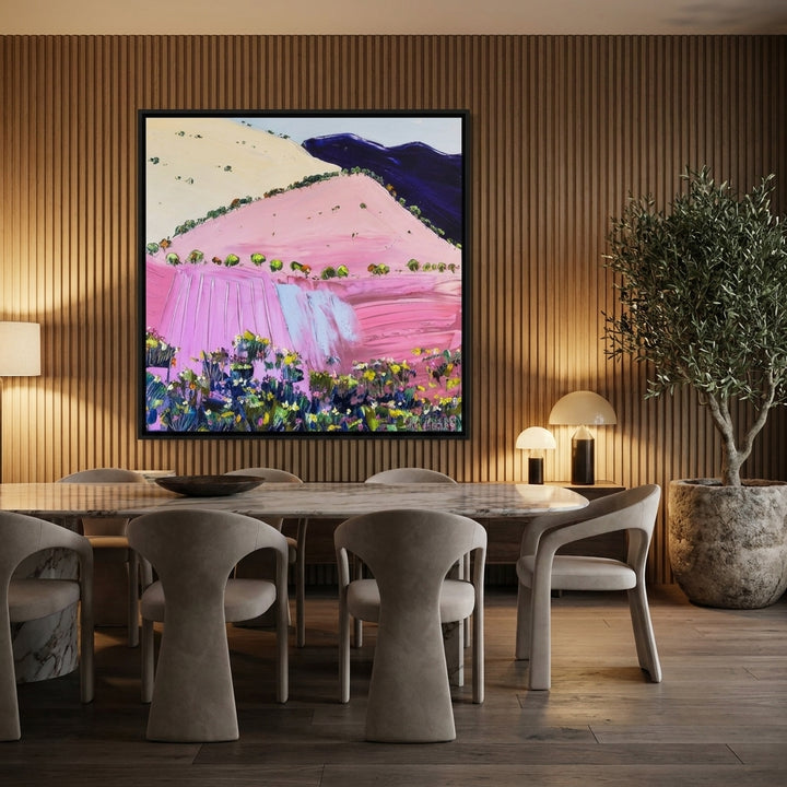Oversized statement canvas wall art with a black surround styled on the wall in a luxe dining room