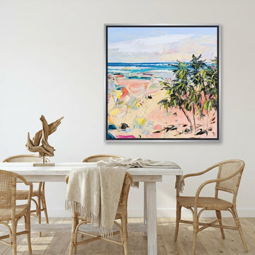 Canvas wall art with a silver leaf surround styled on the wall in a coastal dining room