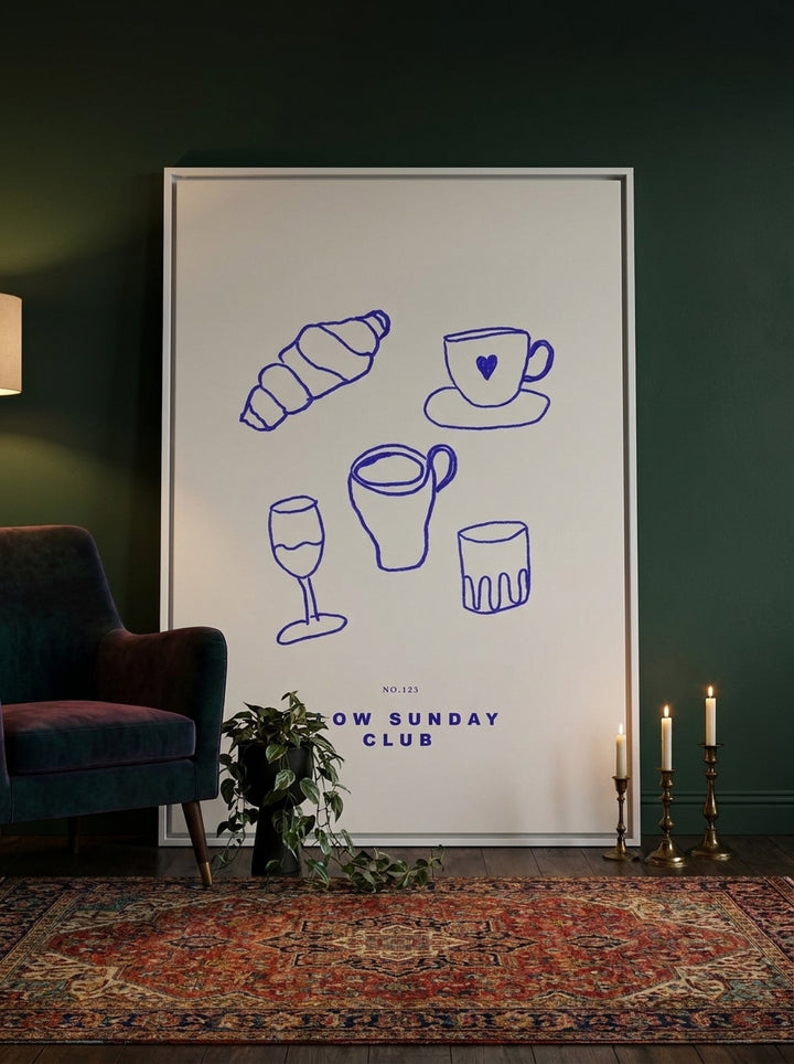 Oversized statement canvas wall art with a white surround leaning against the wall in a moody dining room