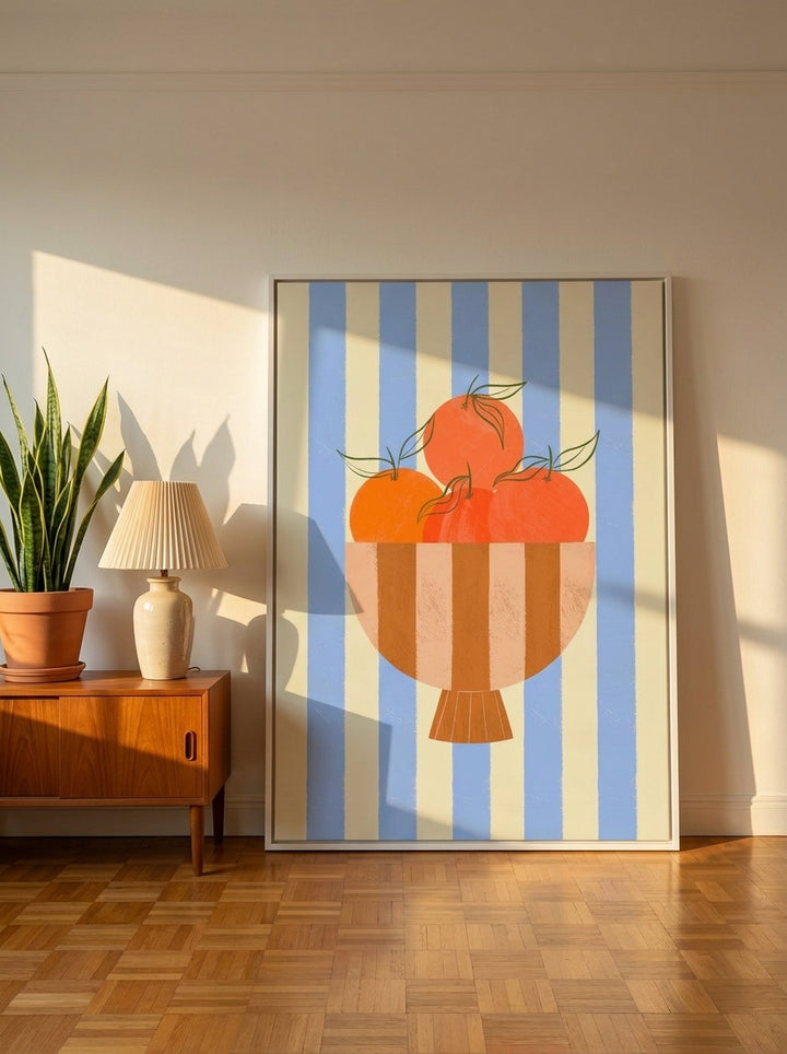 Oversized statement canvas wall art with a white surround leaning against the wall in a mid-century dining room