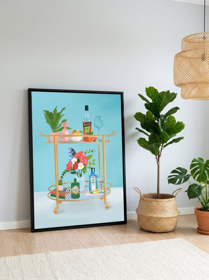 Canvas wall art with a black surround leaning against the wall in a bright Scandinavian dining room