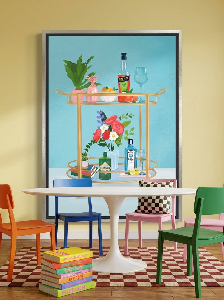 Canvas wall art with a silver leaf surround styled on the wall in a colourful eclectic dining room