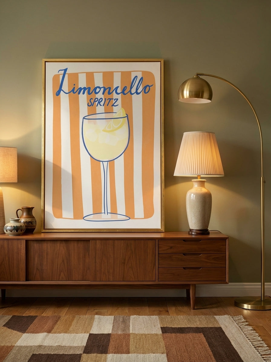 Canvas wall art with a gold leaf surround standing on a sideboard in a mid-century living room