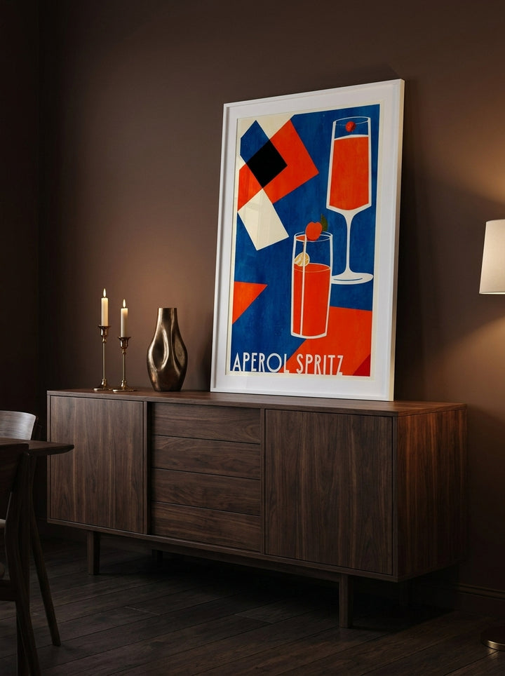 Modern wall art print standing on a sideboard in a moody dining room