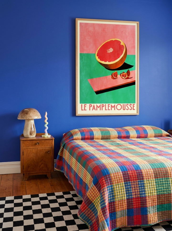 Oversized statement modern wall art print styled on the wall in a colourful eclectic bedroom