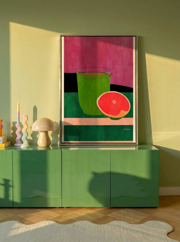 Canvas wall art with a silver leaf surround standing on a sideboard in a colourful eclectic living room