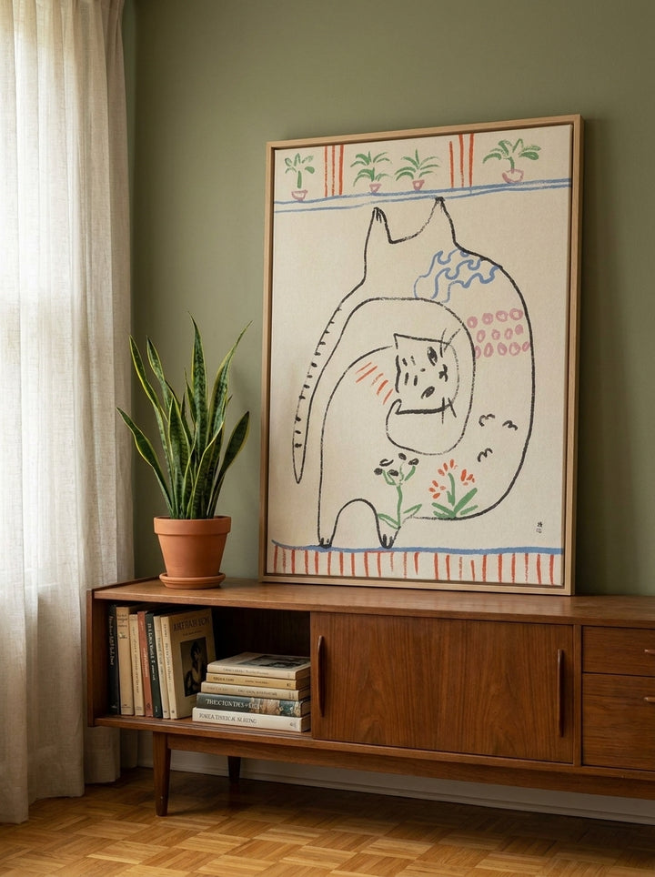 Canvas wall art with a natural timber surround standing on a sideboard in a mid-century bedroom