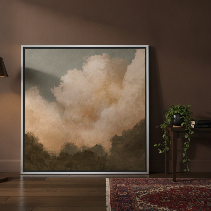 Oversized statement canvas wall art with a silver leaf surround leaning against the wall in a moody living room