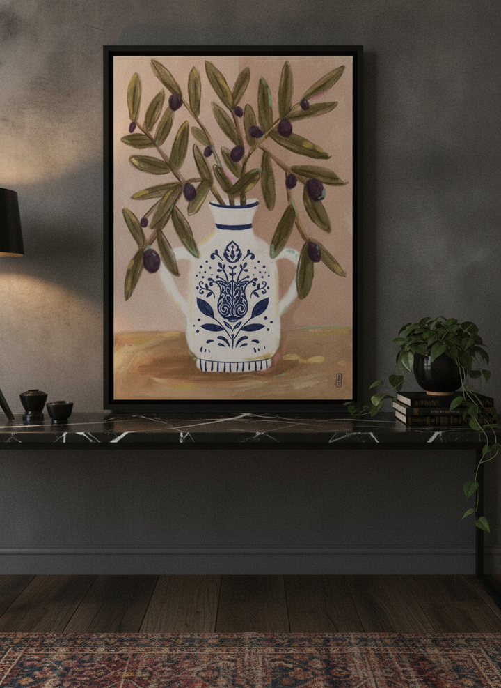 Canvas wall art with a black surround standing on a kitchen bench in a moody kitchen