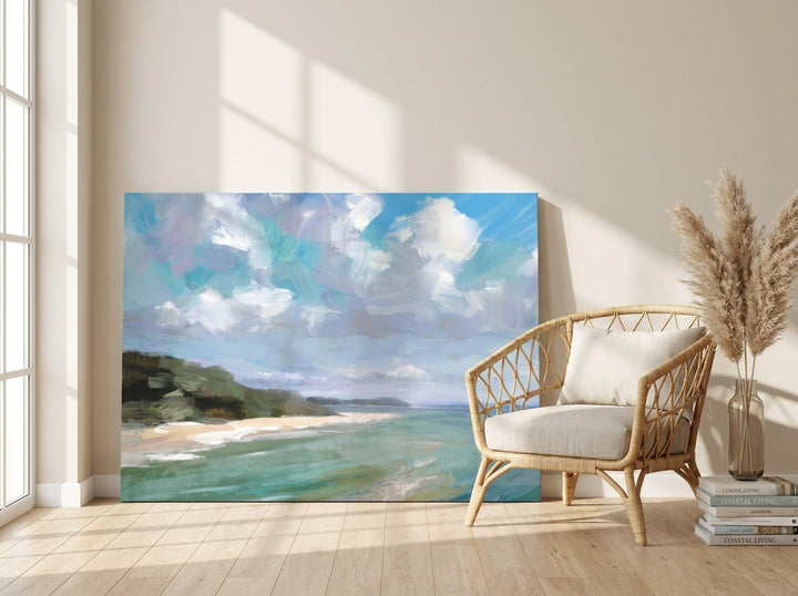 Stretched canvas wall art leaning against the wall in a coastal living room