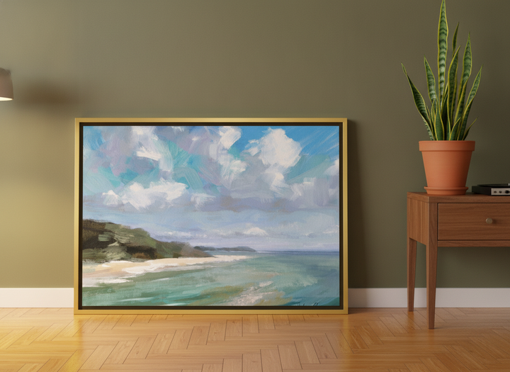 Canvas wall art with a gold leaf surround leaning against the wall in a mid-century home office