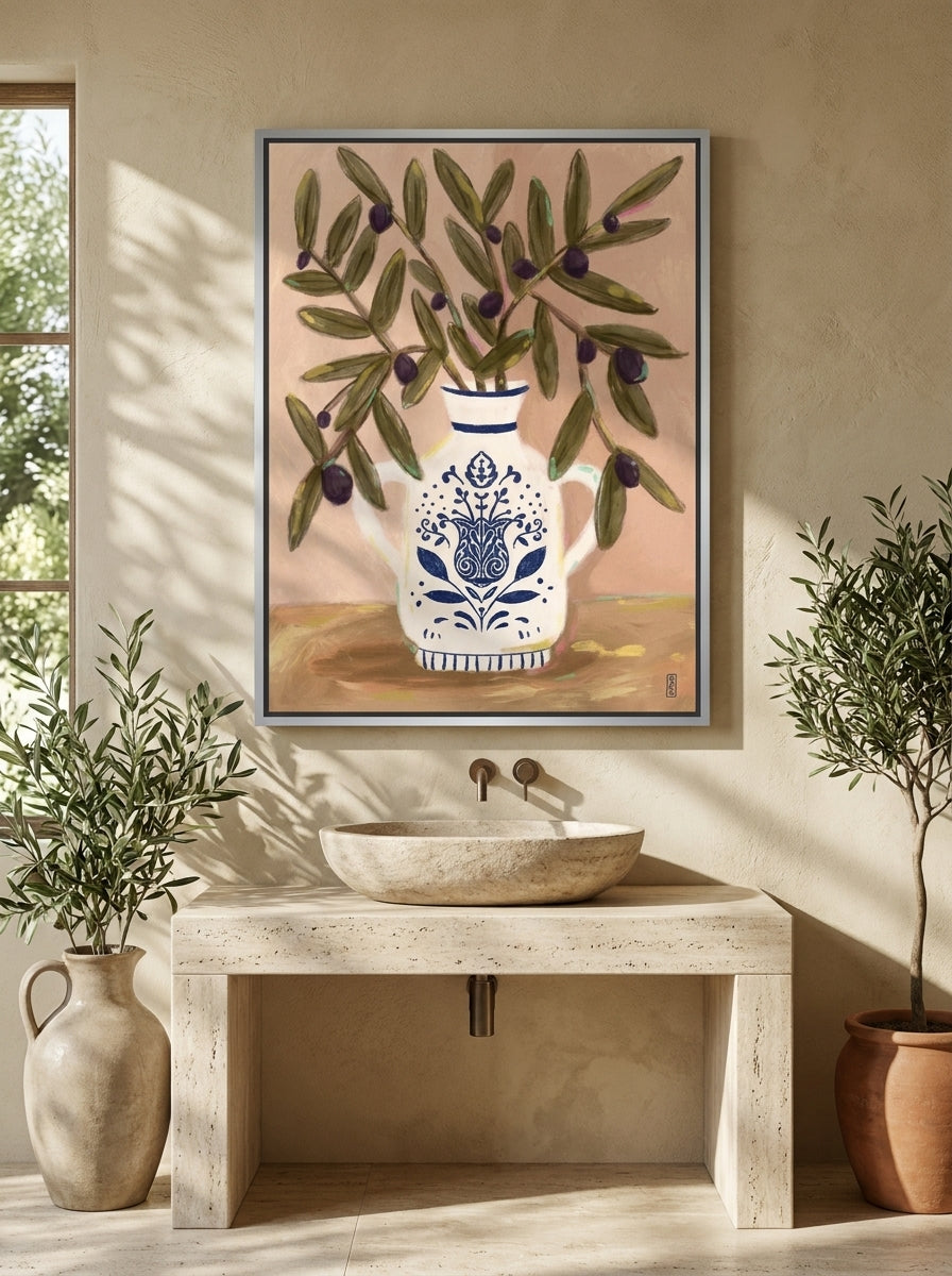 Canvas wall art with a silver leaf surround styled on the wall in a Mediterranean bathroom