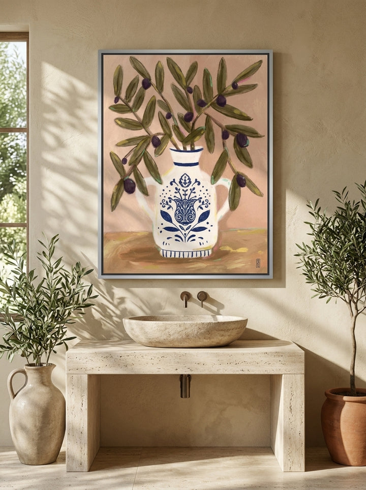 Canvas wall art with a silver leaf surround styled on the wall in a Mediterranean bathroom