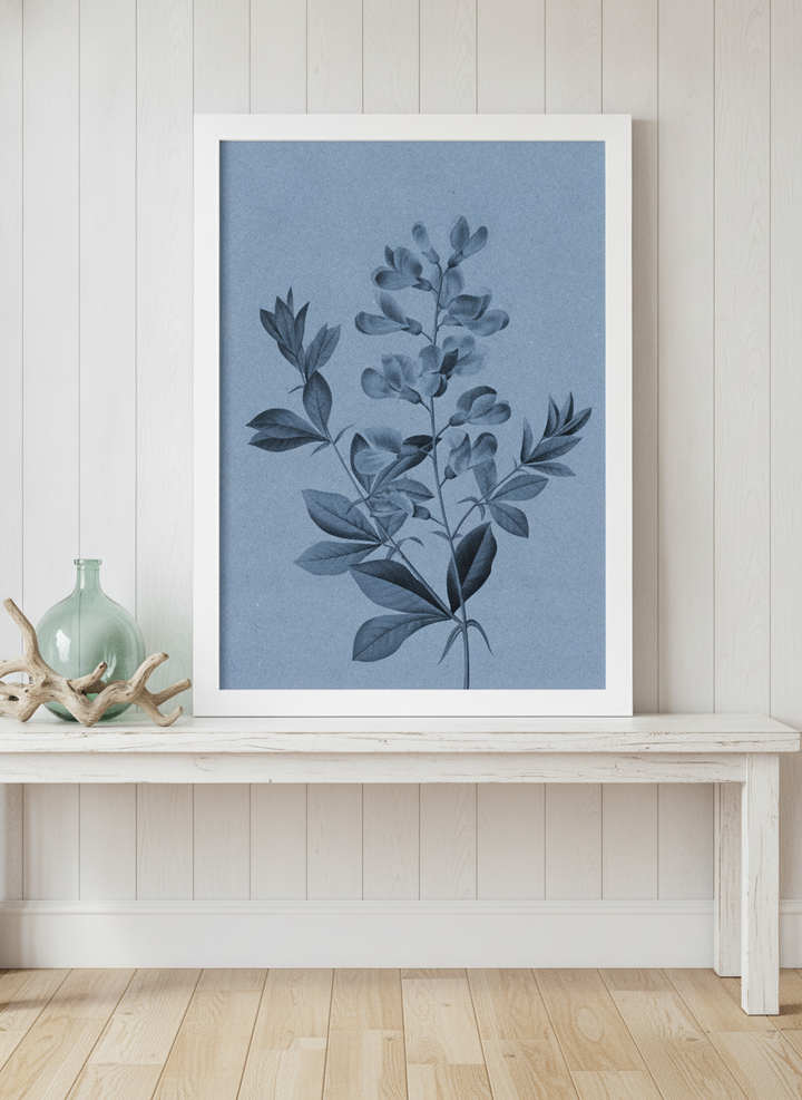 Modern wall art print standing on a console in a coastal bathroom