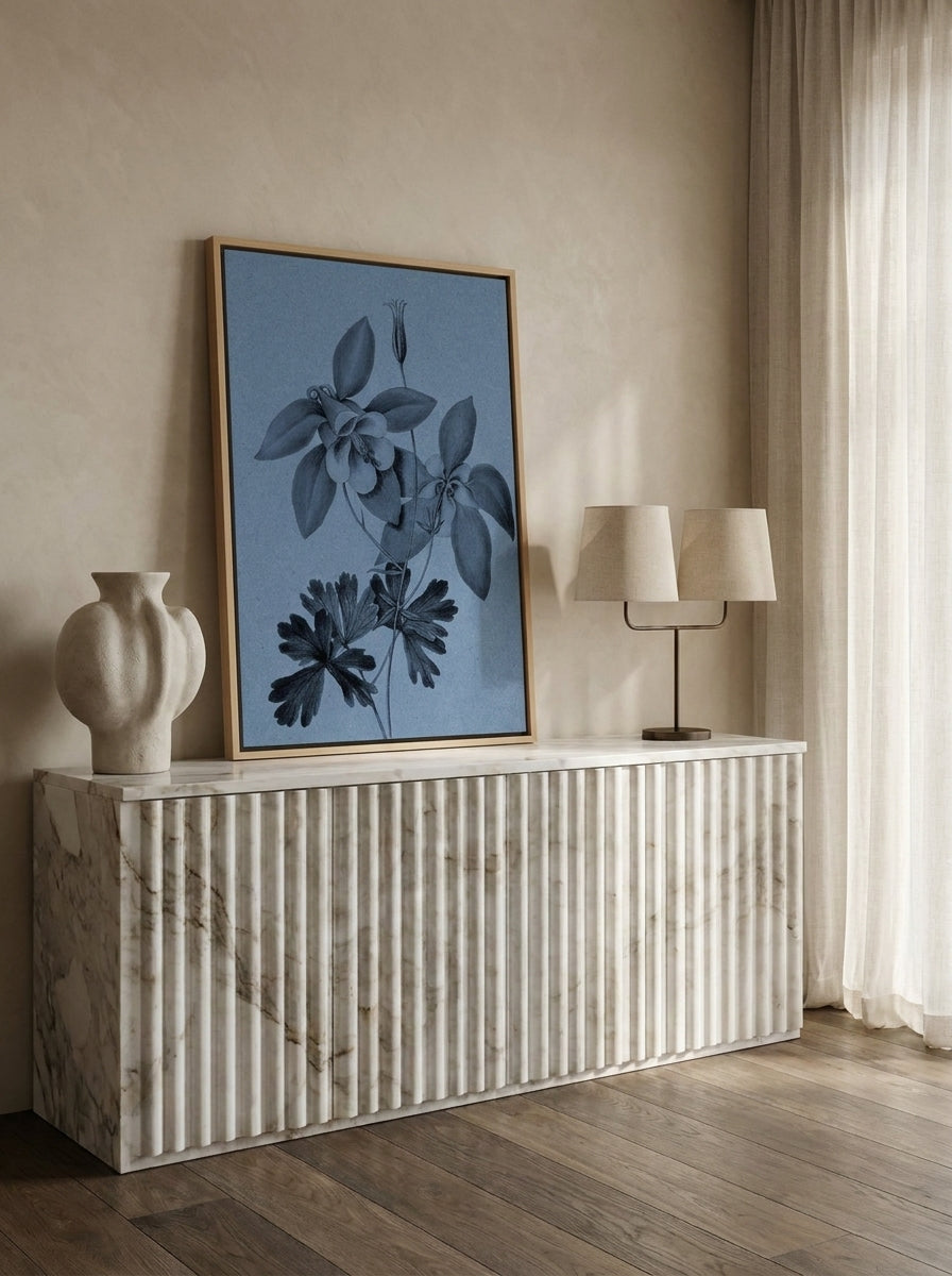 Canvas wall art with a natural timber surround standing on a sideboard in a luxe bathroom