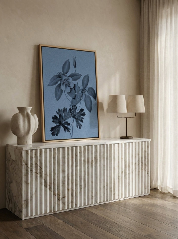 Canvas wall art with a natural timber surround standing on a sideboard in a luxe bathroom