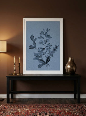 Modern wall art print standing on a console in a moody bedroom
