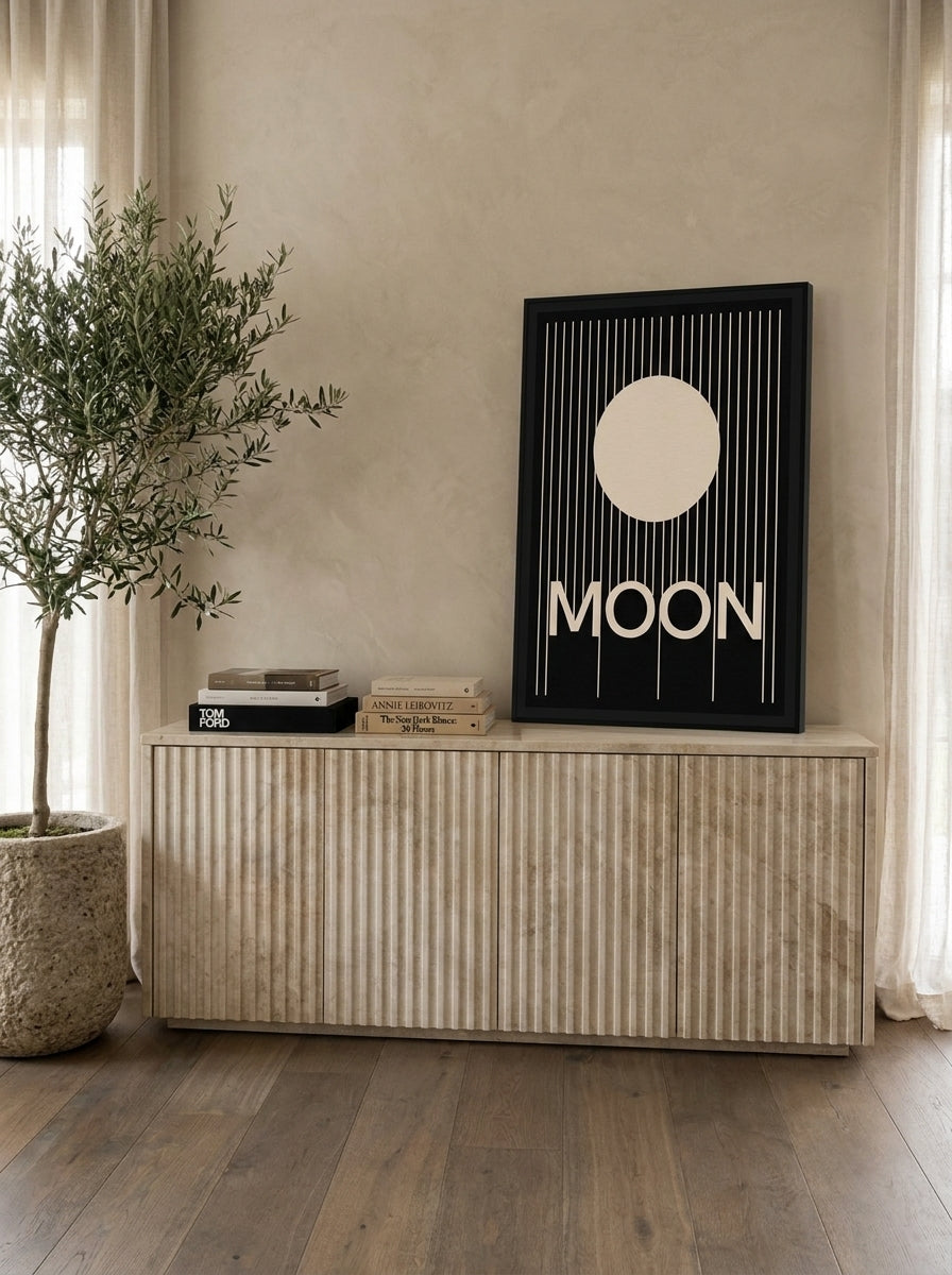 Modern wall art print standing on a sideboard in a luxe living room