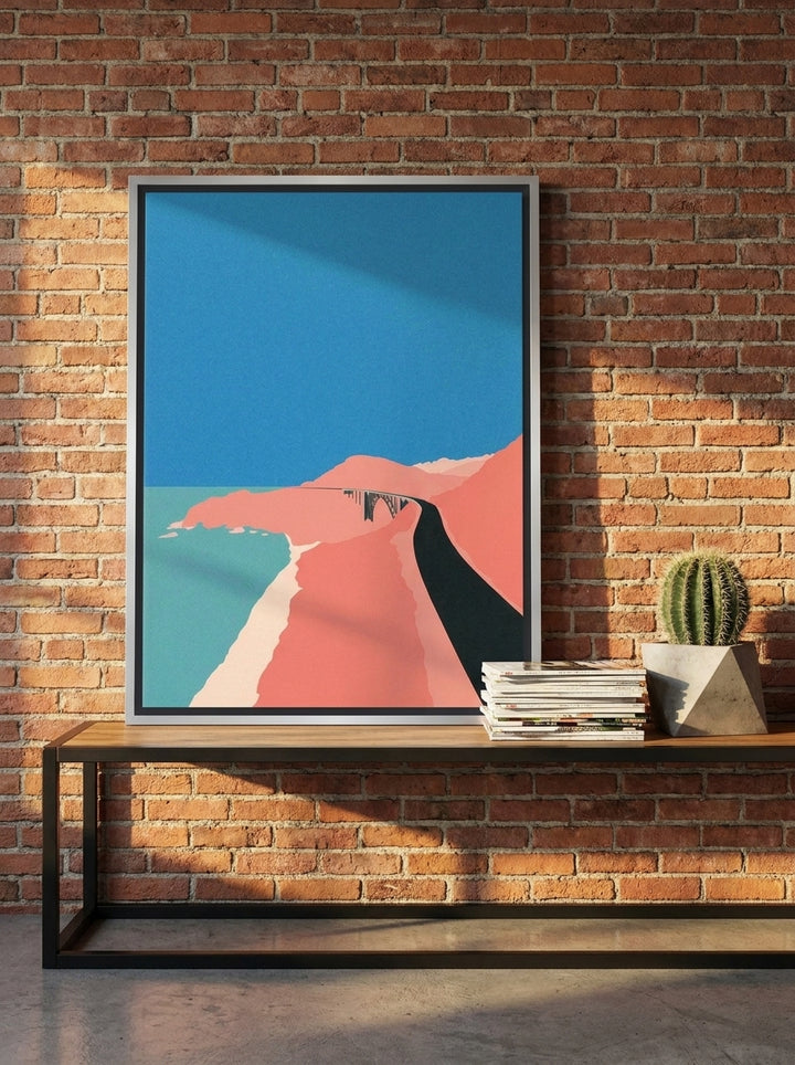 Canvas wall art with a silver leaf surround standing on a console in an industrial loft home office