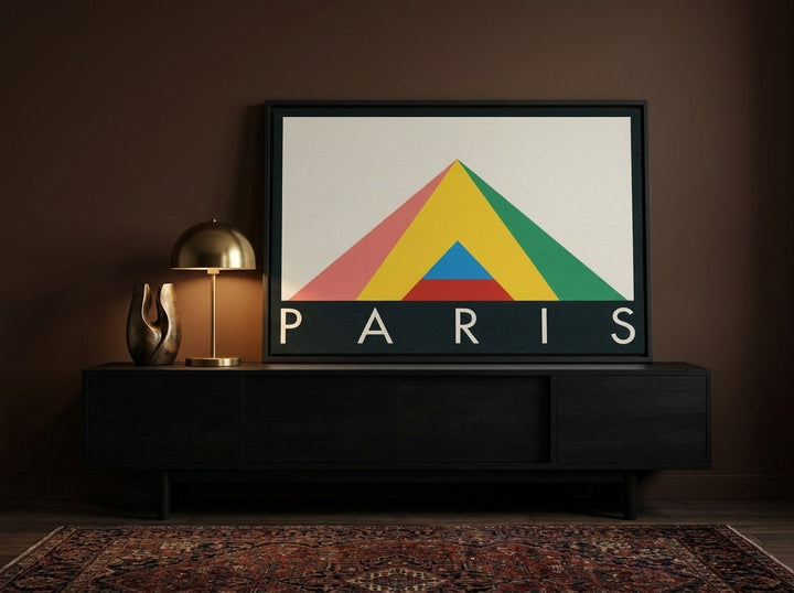 Canvas wall art with a black surround standing on a console in a moody dining room