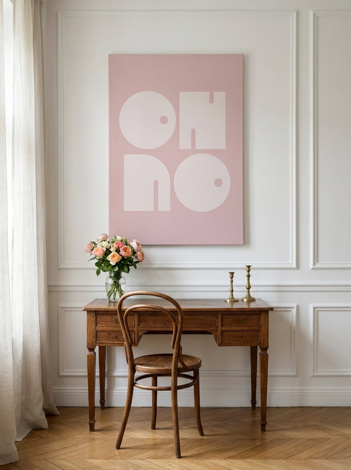 Stretched canvas wall art styled on the wall in a Parisian home office