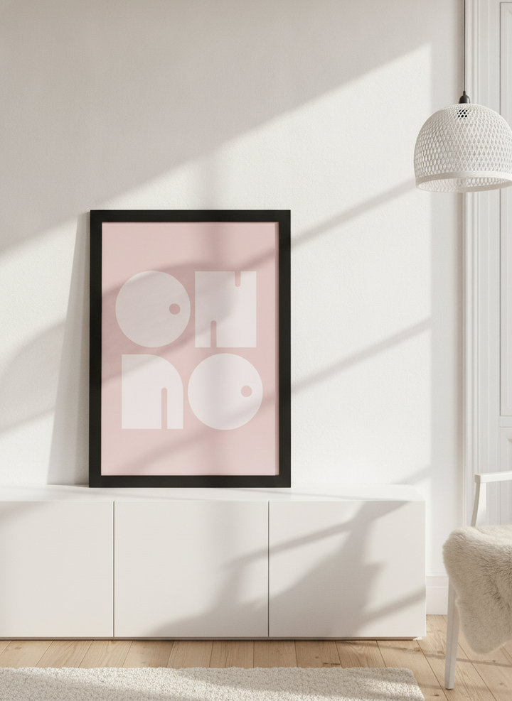 Modern wall art print standing on a sideboard in a bright Scandinavian home office