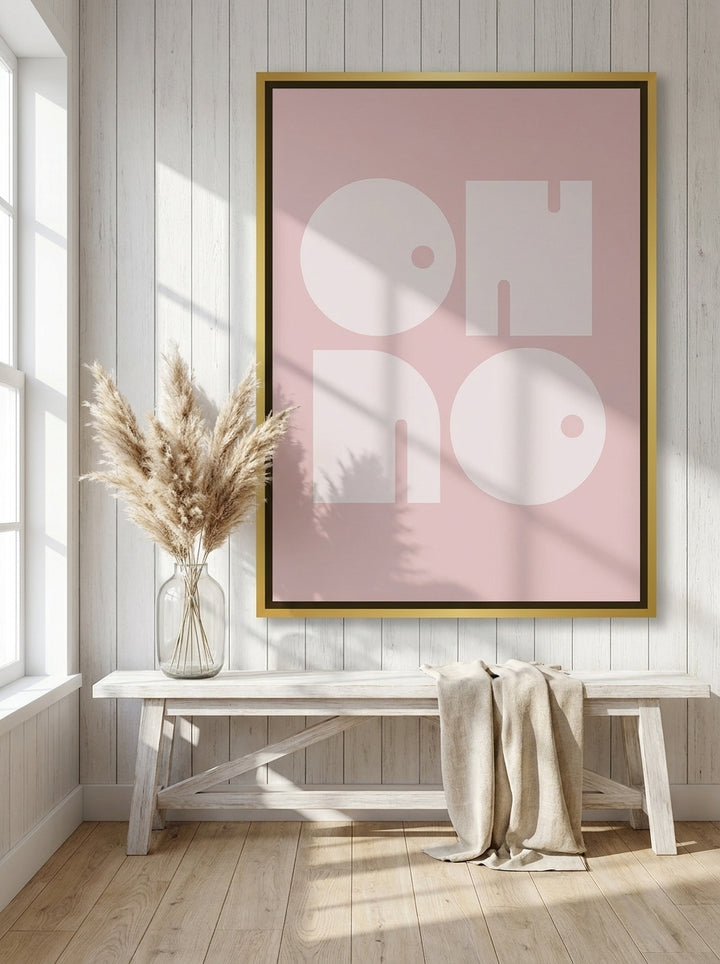 Oversized statement canvas wall art with a gold leaf surround styled on the wall in a coastal living room