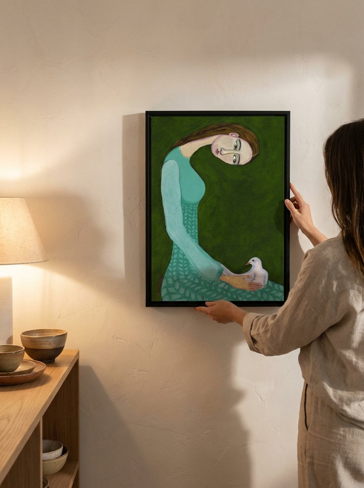Person holding modern wall art print in a warm Japandi living room
