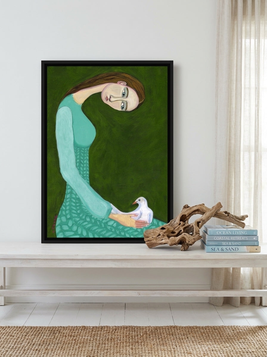 Canvas wall art with a black surround standing on a console in a coastal home office