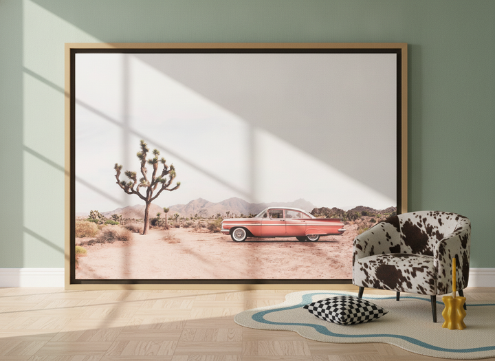 Oversized statement canvas wall art with a natural timber surround leaning against the wall in a colourful eclectic living room
