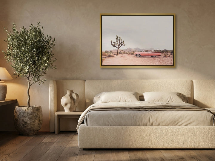 Canvas wall art with a gold leaf surround styled on the wall in a luxe bedroom