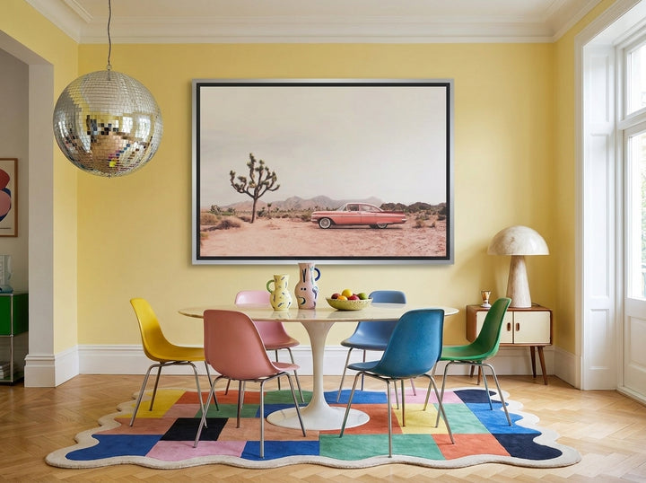 Oversized statement canvas wall art with a silver leaf surround styled on the wall in a colourful eclectic dining room