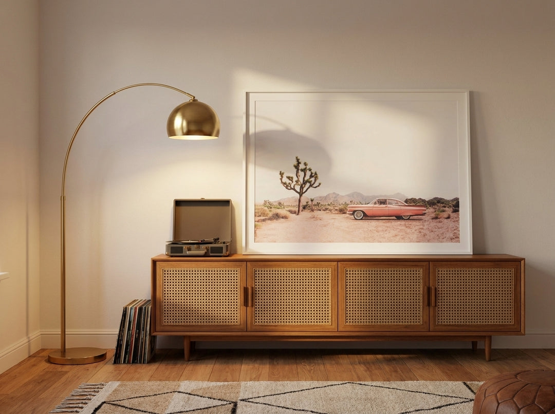 Modern wall art print standing on a sideboard in a mid-century bedroom