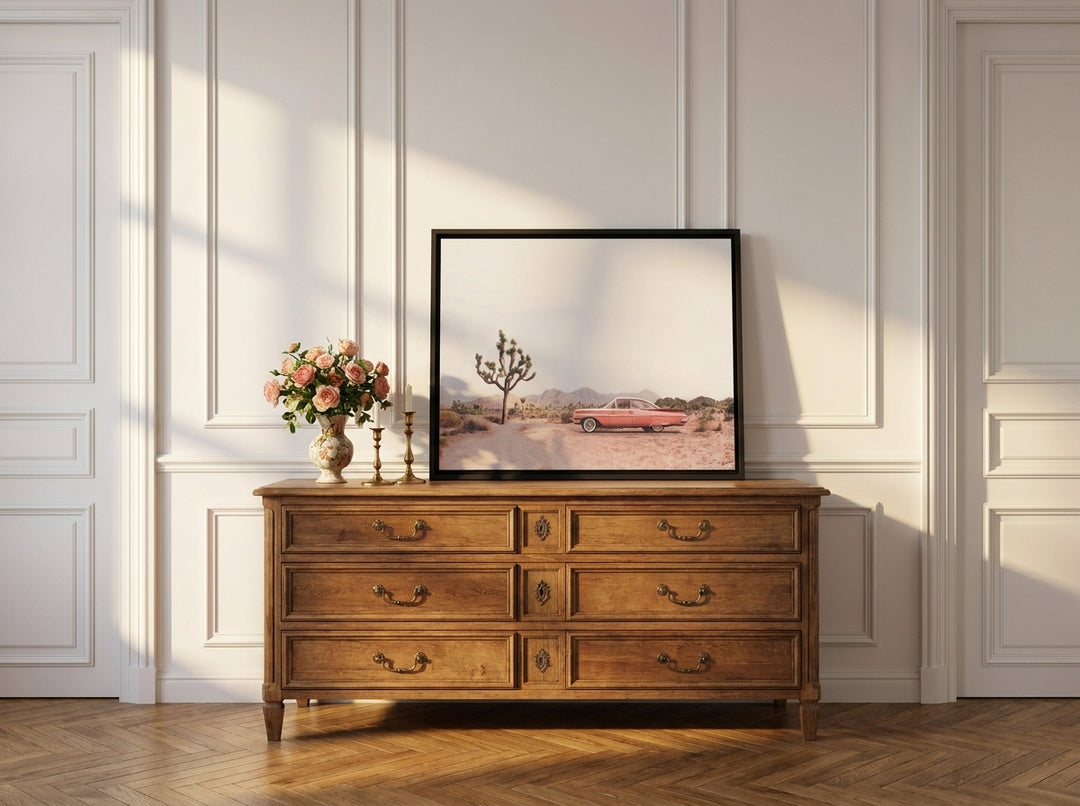 Canvas wall art with a black surround standing on a sideboard in a Parisian living room