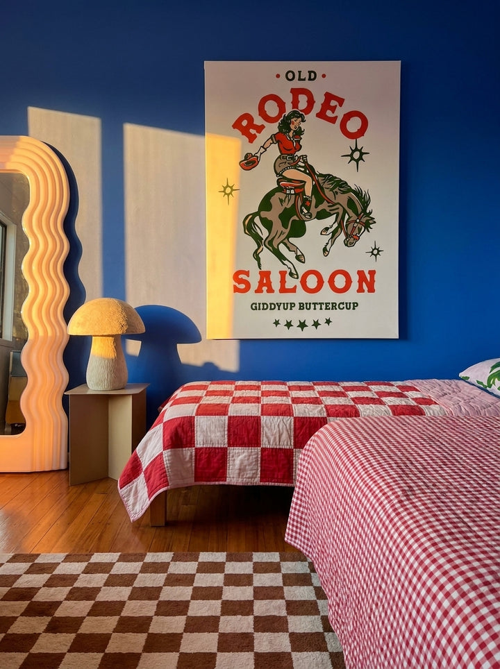 Stretched canvas wall art styled on the wall in a colourful eclectic bedroom