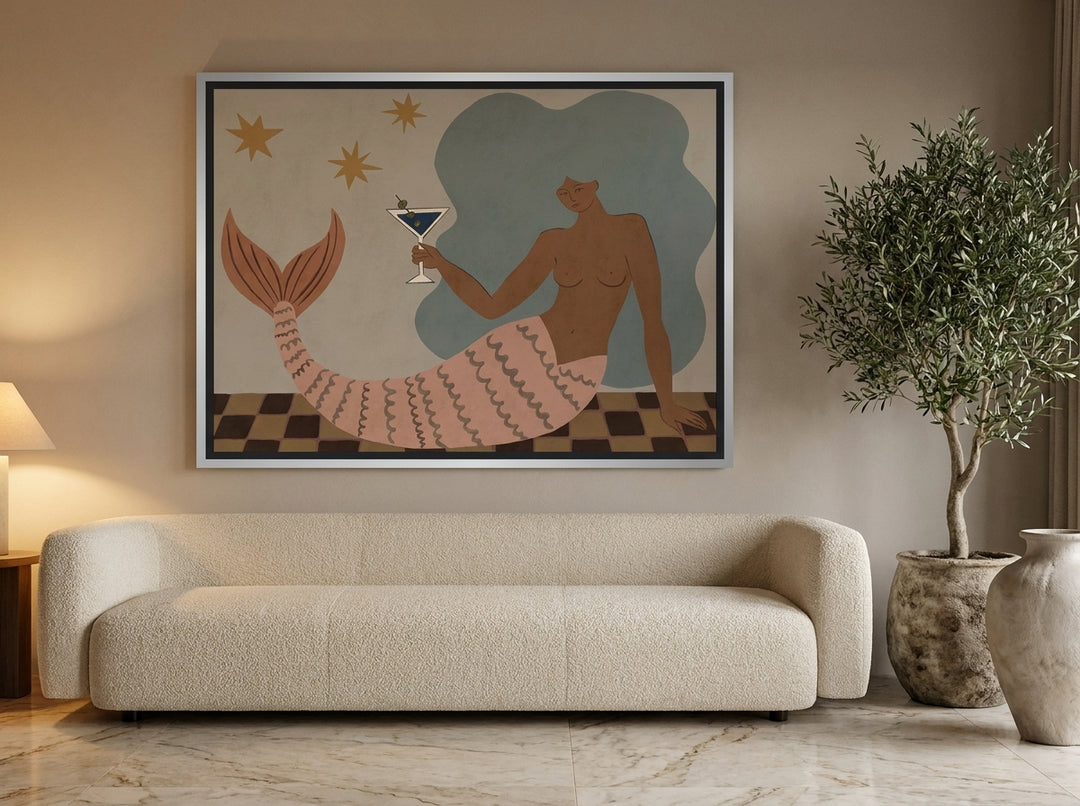 Oversized statement canvas wall art with a silver leaf surround styled on the wall in a luxe living room